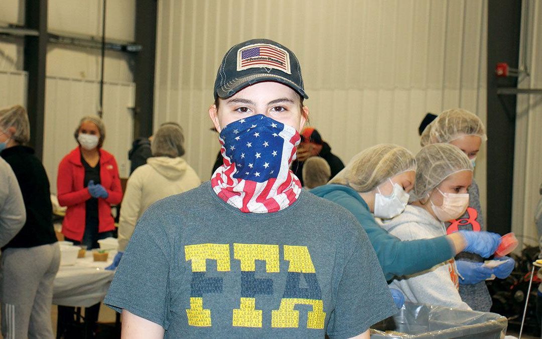 Teenager raises funds, volunteers to package food for community