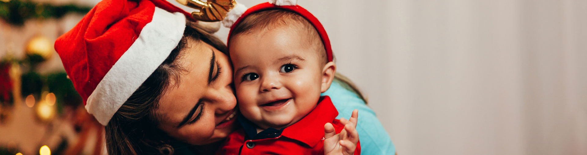 hwh-santa-hats Mother and baby wearing Santa hats